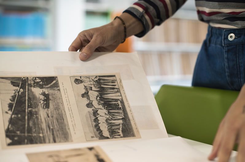 Person looking at photographs from the collection