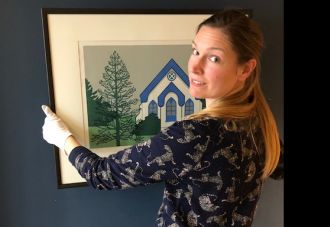Laura Woodward, Wellington City Council Collections Registrar with artwork by Robin White titled Southland Monkey Puzzle, 1973